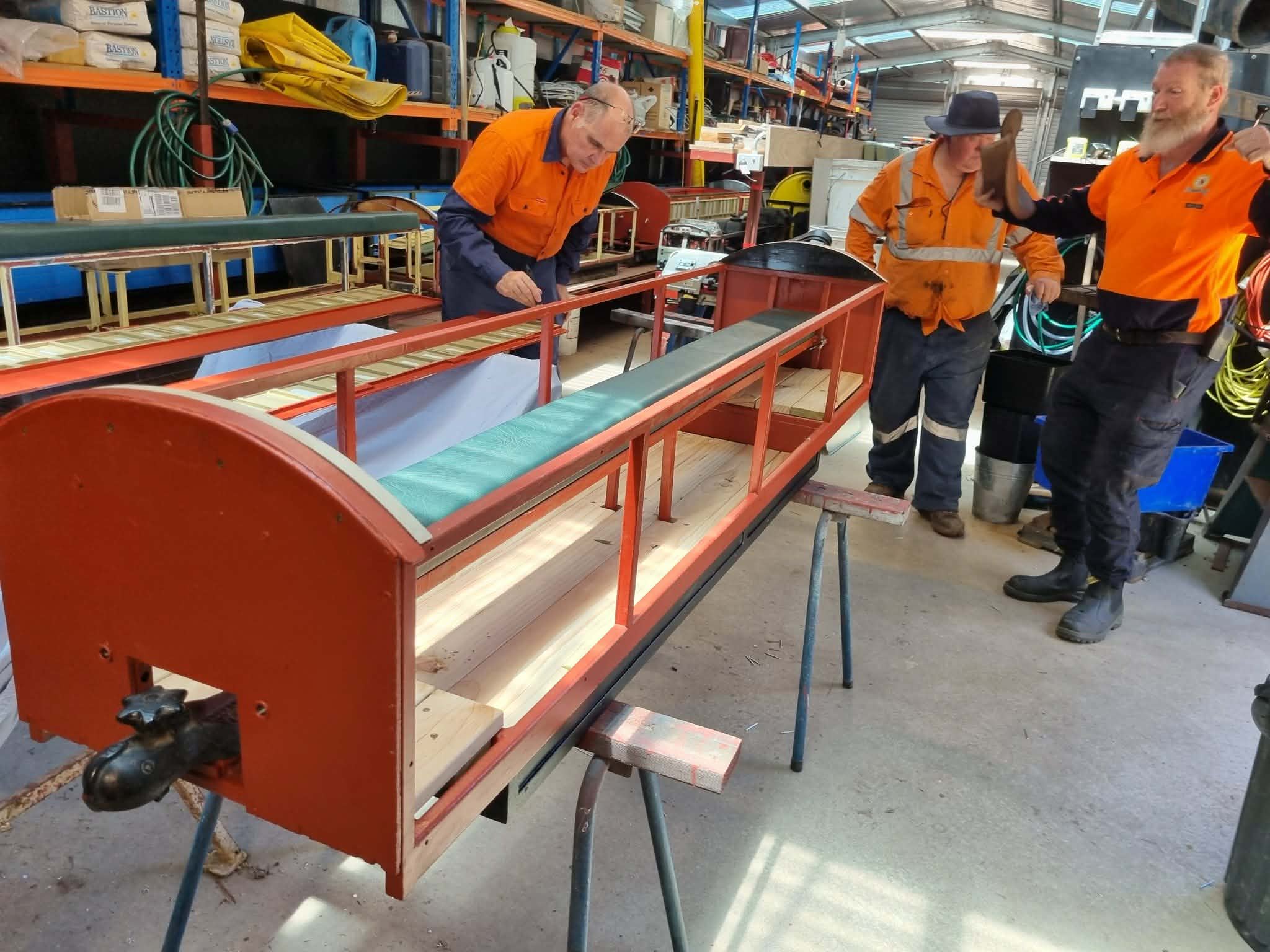 Club members working on carriage restoration in the workshop